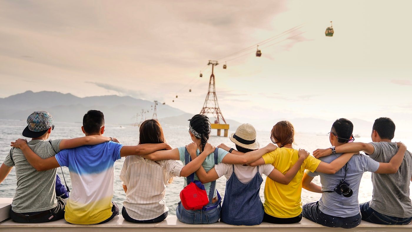 Group of people sitting together at dusk